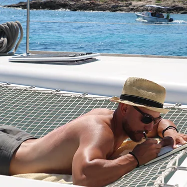 Chris journaling on a boat