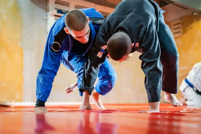 Two men grappling on the ground