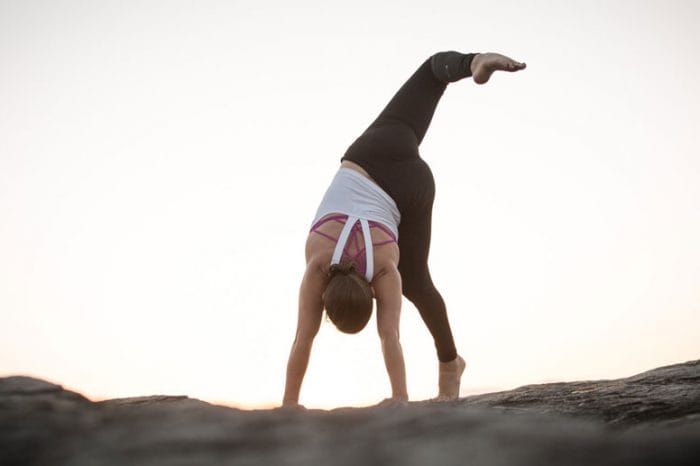 Animal Flow Master Instructor Alisha Smith performs a Scorpion Reach.