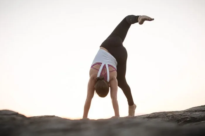 Animal Flow Master Instructor Alisha Smith performs a Scorpion Reach.