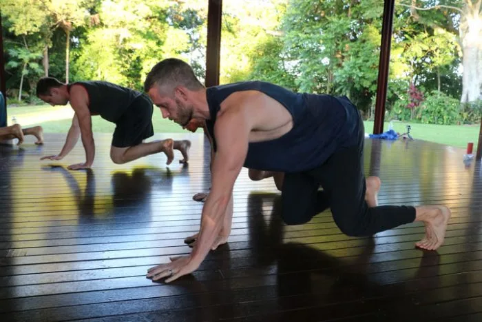 Two men practice Reverse Traveling Beast