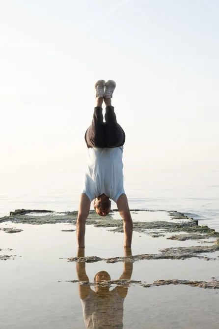 Master Instructor Roshan Chopra performs a Tuck Balance