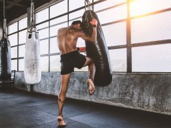 Kickboxer training with bag